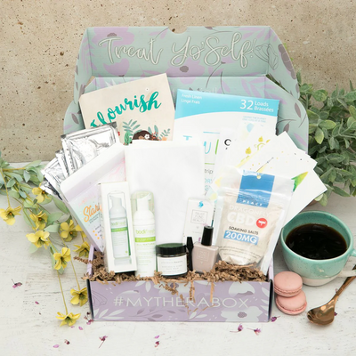 TheraBox Flourish box featuring Aminnah Starry Collagen Gel Eye Pads, Alt Linen Kitchen Towels, Plant Based Beauty Avocado + Algae Mask, Dragonfly Soaking Salts, Tru Earth Eco Strips Laundry Detergent, Trust Fund Beauty No Filter Nail Polish, Bodifresh Dew Drops of Spring, Curious Cards Garden of the Mind
