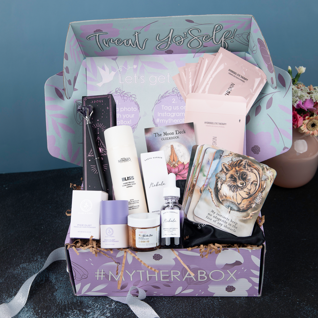 TheraBox Moon Spell Box featuring AYNIL.CO | Amethyst Crystal Pen, PLUM & POPPY | Pixie Dust Rescue Hair Powder, AMINNAH | "Kiss the Stars" Lip Plumping Mask, EVIO | Pink Perspective Hydrogel Eye Therapy Masks, MINIMO | Bliss Magic Erase Dark Spot Body Lotion, EARTH HARBOR | Nebula Adaptogen Clarity Ampoule, and THE MOON DECK | Moon Deck Oracle and Guide Book