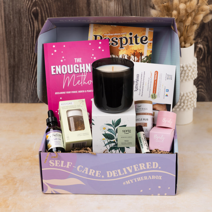 TheraBox Respite Box featuring Nature's Inventory | Liquid Herbal Extract - Chill Out, Bgirly Lipsauce | Vanilla Sugar Cookie Lip Scrub, Kind Lips | Premium Lip Balm (Sweet Mint), Lue by Jean Seo | Restore To-Go Moisturizer Capsules, Top It Off | Touch-Screen Fingertip Gloves (Various Designs), Sprig By Kohler | Relax Scented Candle (Chamomile + Green Tea), J&L Naturals | Muscle Rub - Cinnamon & Clove 2.2OZ., COLORFULZONE | Astromind App (6-Months), and Carrie Severson | The Enoughness Method