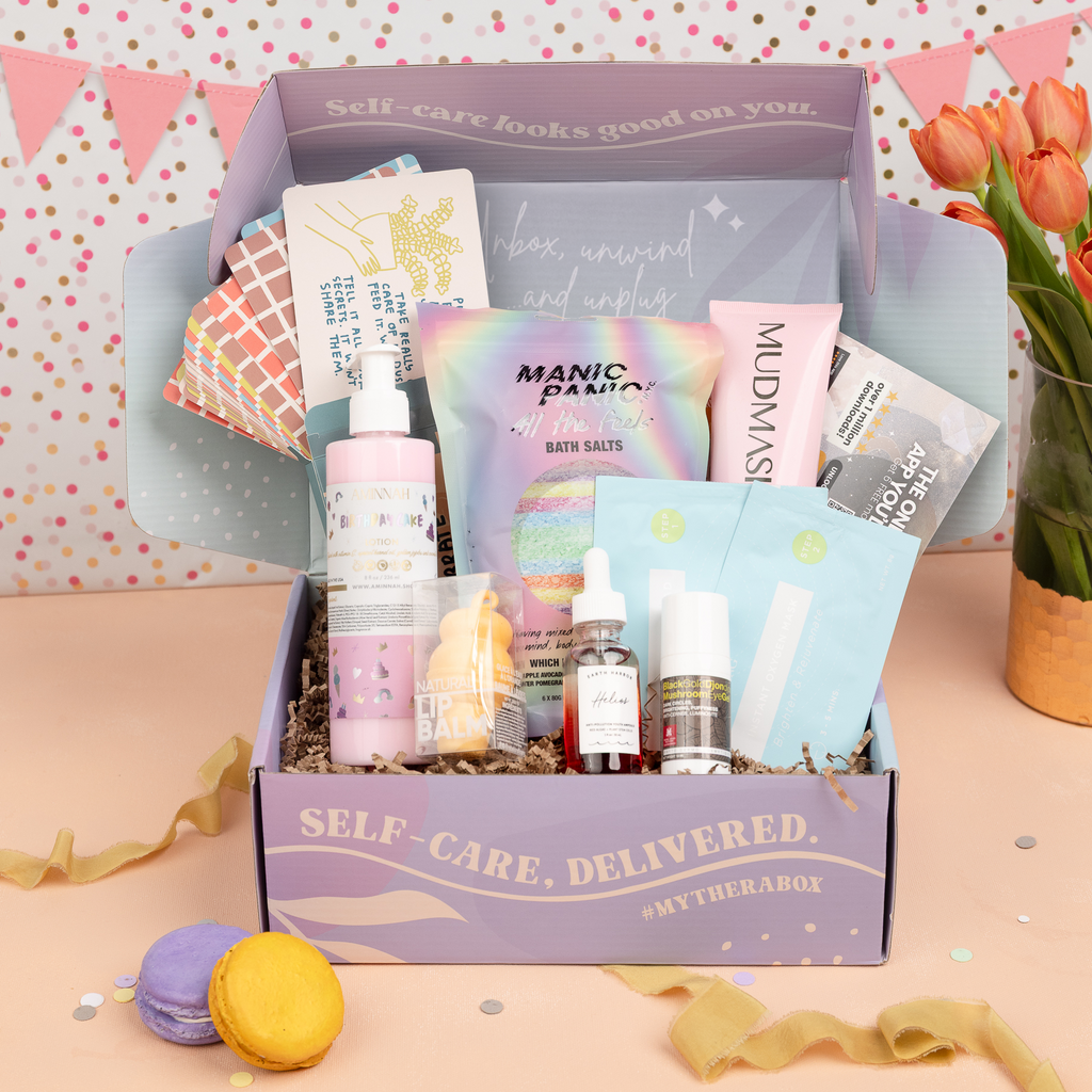 TheraBox Celebr8te Box featuring Aminnah | Birthday Cake Lotion, Earth Harbor | Helios Anti-Pollution Youth Ampoule, Ling Skincare | Instant Peeling Pad + Instant Oxygen Mask, Rebels Refinery | Ice Cream Lip Balm Orange Dreamsicle, Mudmasky | Velvety Glow Body Scrub, Morganna's Alchemy Skincare | Black Gold Mushroom Eye Gel, Manic Panic | All The Feels Bath Bomb OR Bath Salt, People You've Loved | Excuses to Celebrate Deck and Saged App | 6 Months of Saged Premium