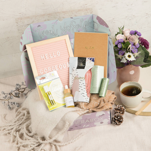 TheraBox Cozy box featuring All You Need is Love | Ombre Fringe Scarf, J&L Naturals | Orange Cedarwood Growth Hair Serum, Scentered | De-Stress Wellbeing Ritual Aromatherapy Balm, The Happy Shopee | Felt Letter Board, Tastea Heaven | Beauty Tastea, Clear My Head | Clear My Head 2 Go, Sara Salam | My Truth Journal *Note: Pen not included