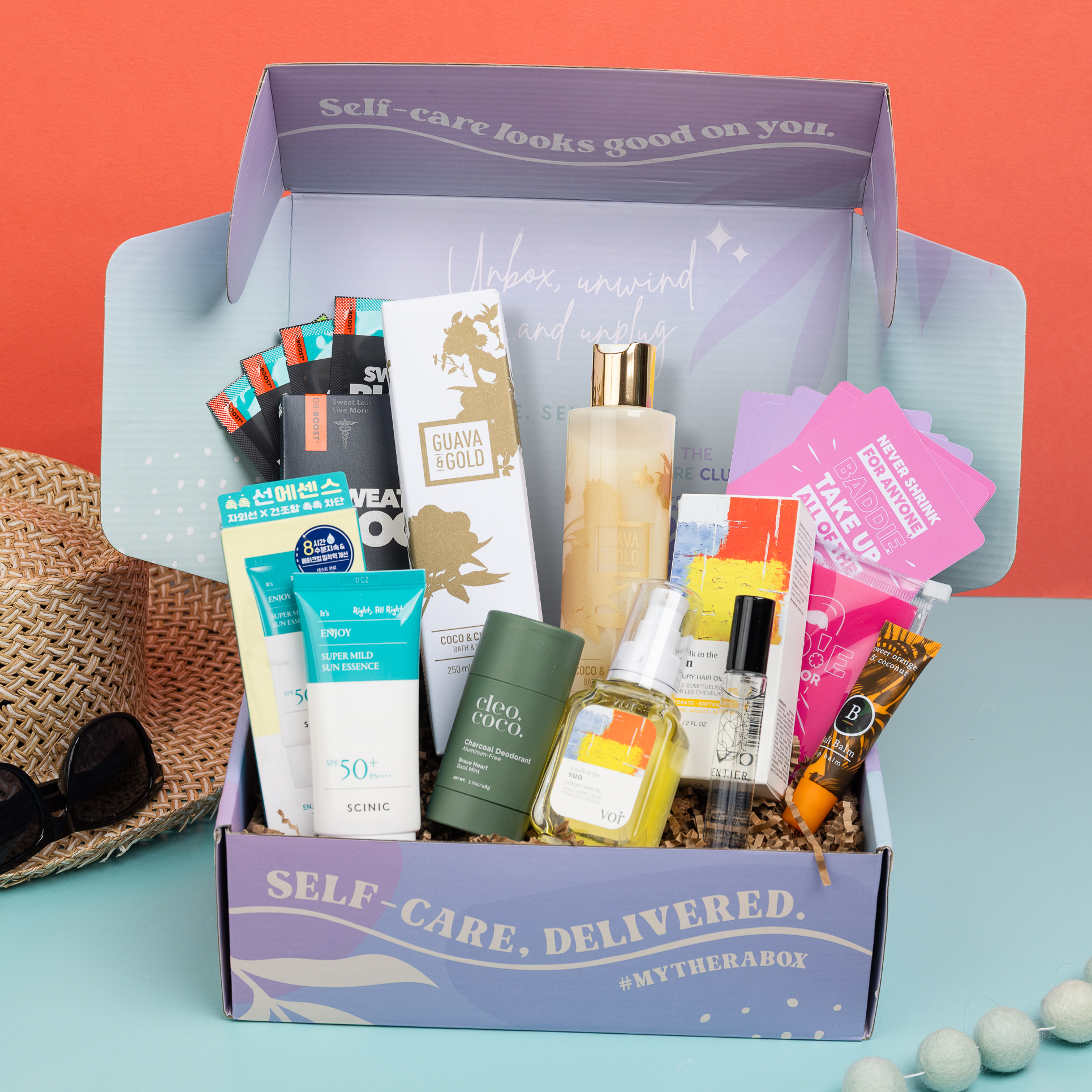TheraBox Sunshine box featuring Scinic | Enjoy Super Milk Sun Essence (SPF 50+ PA++++), Voir Haircare | A Walk In The Sun: Luxury Hair Oil 60ml, Sentier | Lost Summers Fragrance, Guava and Gold | Bath and Shower Gel: Coco & Cherimoya, Bali Balm | Lip Balm, Sweatblock | Max Clinical Antiperspirant Wipes,  Cleo & Coco | Charcoal Deodorant, and Wise Awakening | Baddie in the Mirror Shower Affirmations