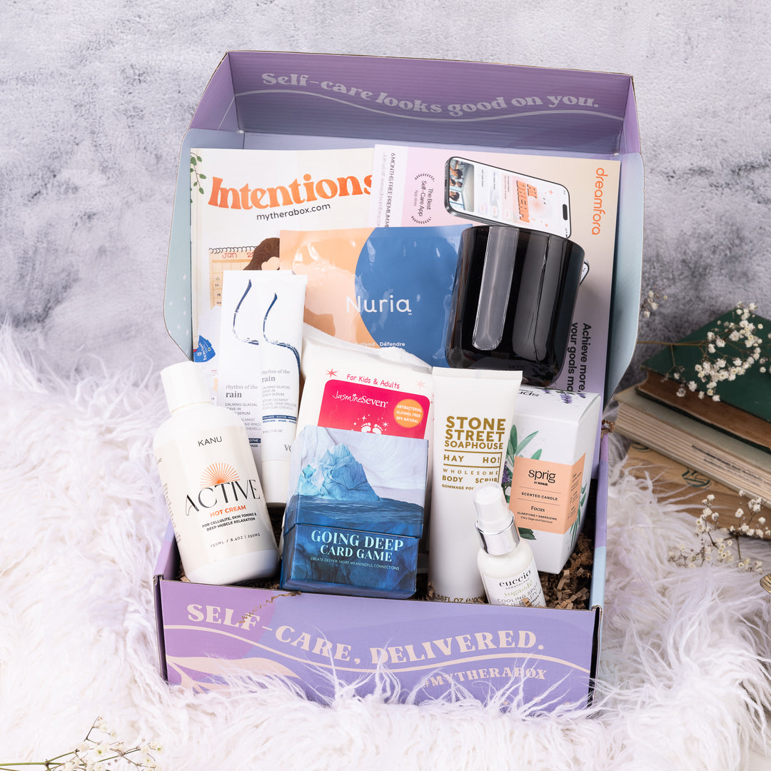 TheraBox Intentions Box featuring Voir Rhythm of the Rain Scalp Serum, Kanu Active Hot Cream, Jasmine Seven Fresh Feet Wipes (scents vary), Sprig Focus Candle, Cucciosomatology Cooling Therapy, Nuria Defend Mask,  YogaApp, Dreamfora