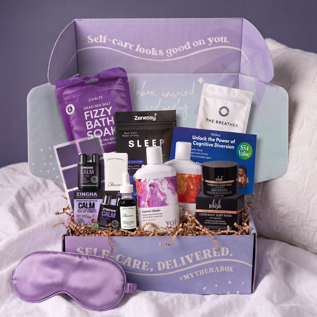 The TheraBox Goodnight box features ZENESSY Sleep Support Patches, EARTH HARBOR Obscura Night Repair Concentrate, WHISH BEAUTY Overnight Sleep Mask, Z!NGHA Calm Aromatherapy On-the-Go, ZAALTS Lavender Dead Sea Salt Fizzy Bath Soak, VOIR HAIRCARE Sunrise Ritual Shampoo, VOIR HAIRCARE Sunset Ritual Conditioner, KOMUSO DESIGN | The Breather + KOMUSO Method E-Course, and a WIKISLEEP 6-Month Premium Subscription.