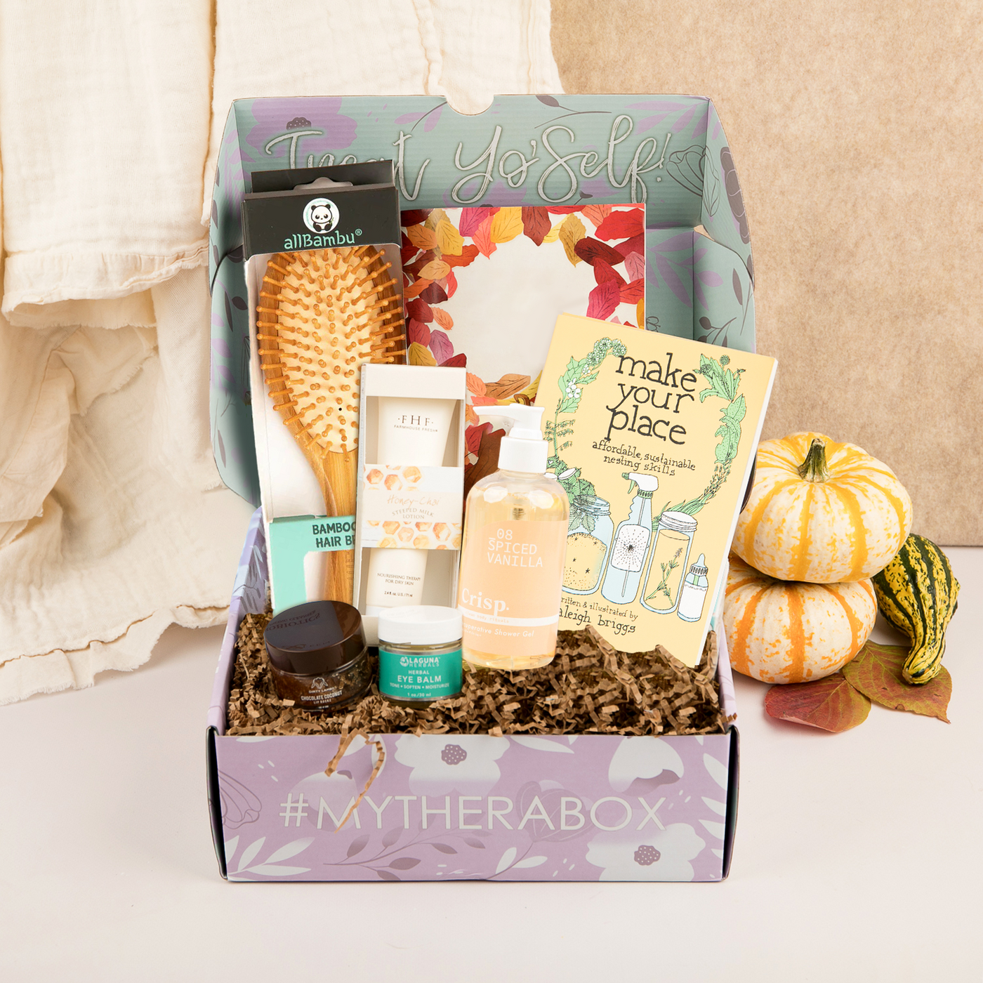 TheraBox Fall Mini box featuring Laguna Herbals | Herbal Eye Balm, Dirty Lamb | Chocolate Coconut Lip Rockz, allBambu | Bamboo Pin Hairbrush, FarmHouse Fresh | Honey-Chai Steeped Milk Lotion for Hands, Crisp | Spiced Vanilla Recuperative Shower Gel, Microcosm Publishing | Make Your Place: Affordable, Sustainable Nesting Skills by Raleigh Briggs