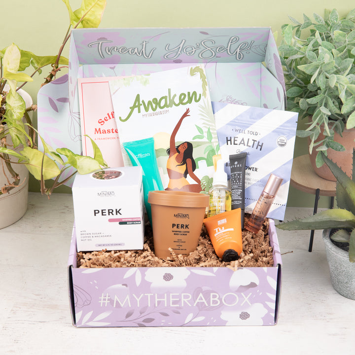 Therabox Awaken box featuring 9 self care items ranging from bath and body to skincare items