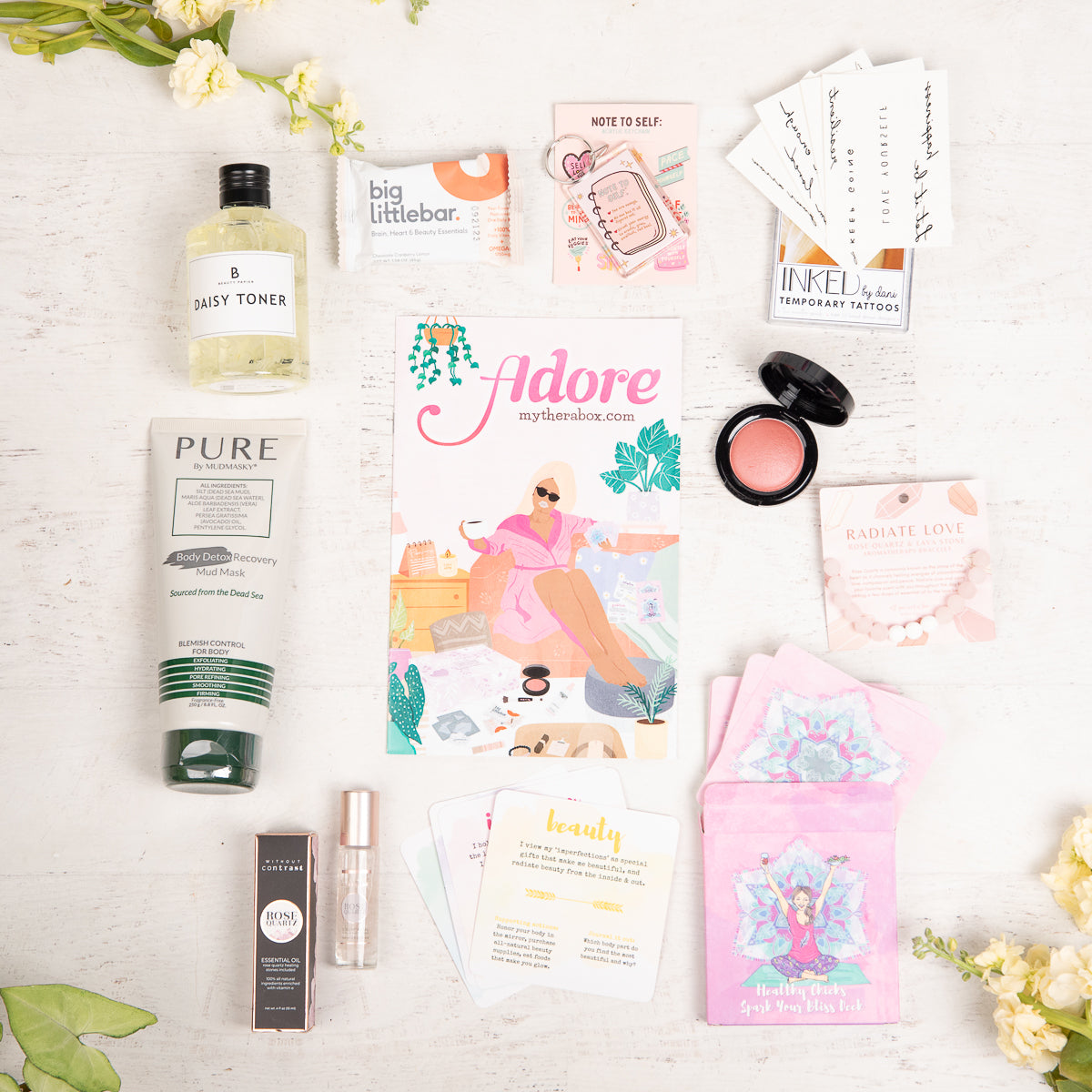 Therabox adore box featuring 9 self care items ranging from bath and body to skincare items